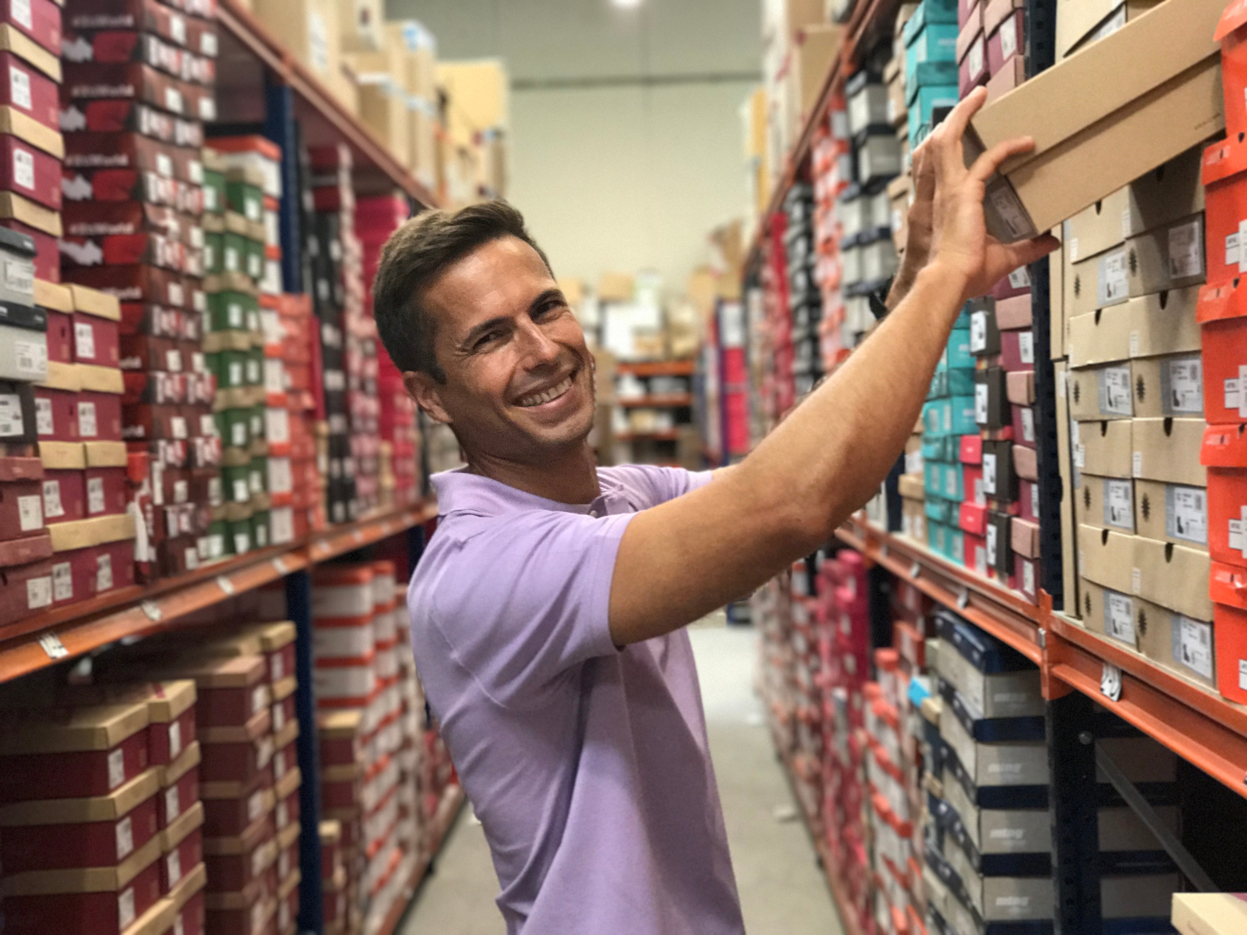 Man stacking shoe boxes