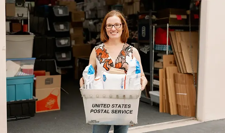 eBay seller holding USPS packages